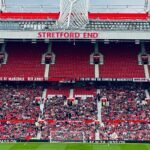 View of the Stretford End crowd at Manchester's iconic stadium during a day event.